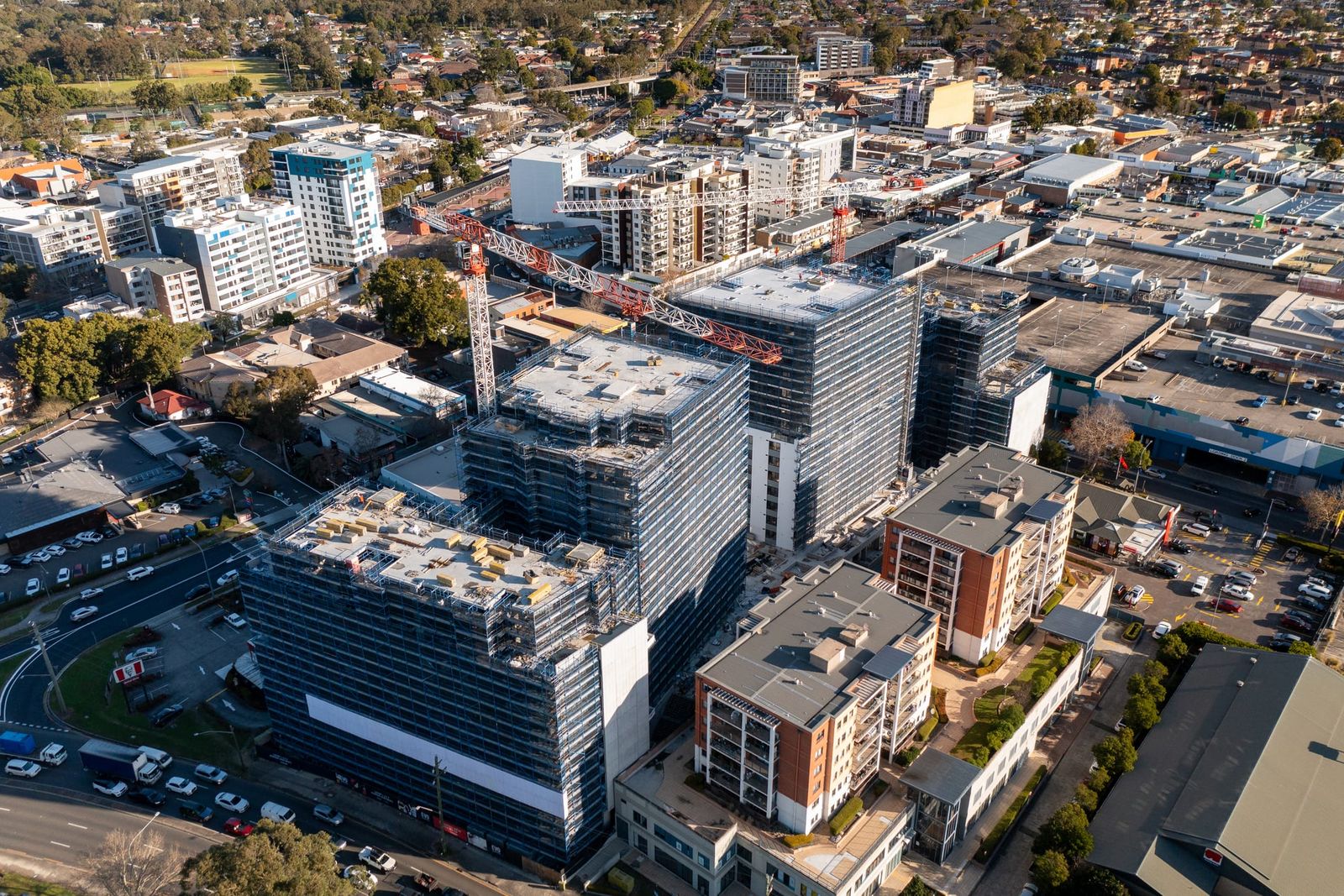 High view over the town centre, the scaffolded towers and cranes among shops and apartment blocks