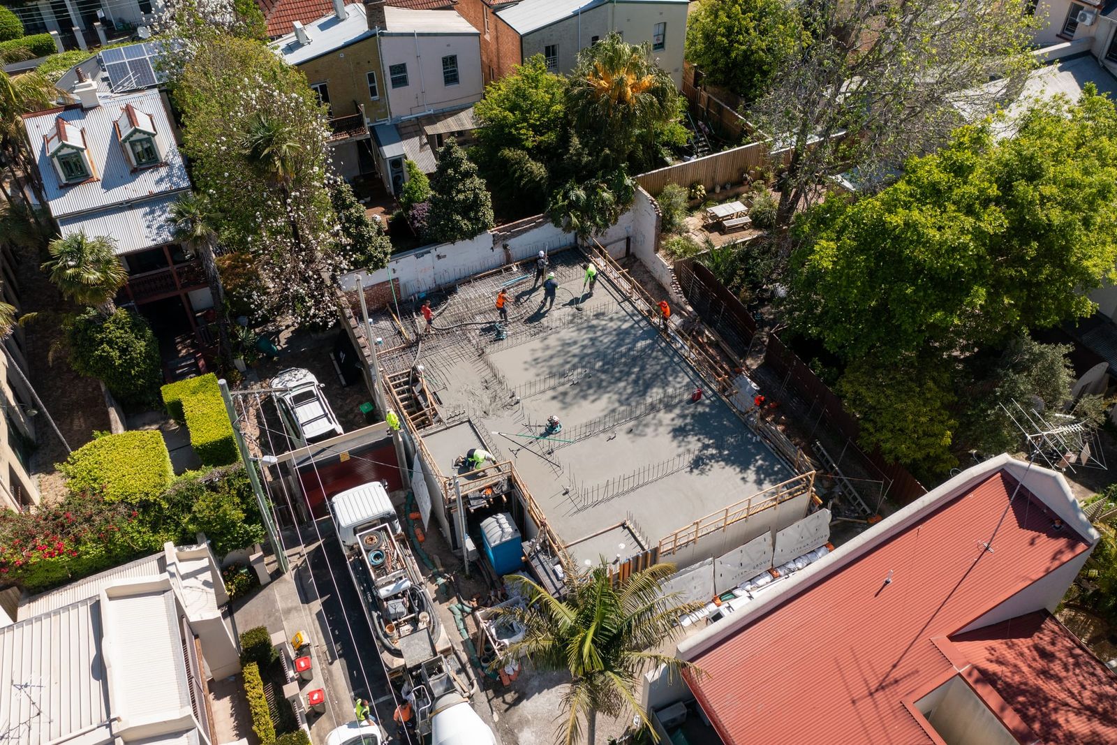 The slab between a terrace house and the laneway, the concrete pump and agitator parked alongside