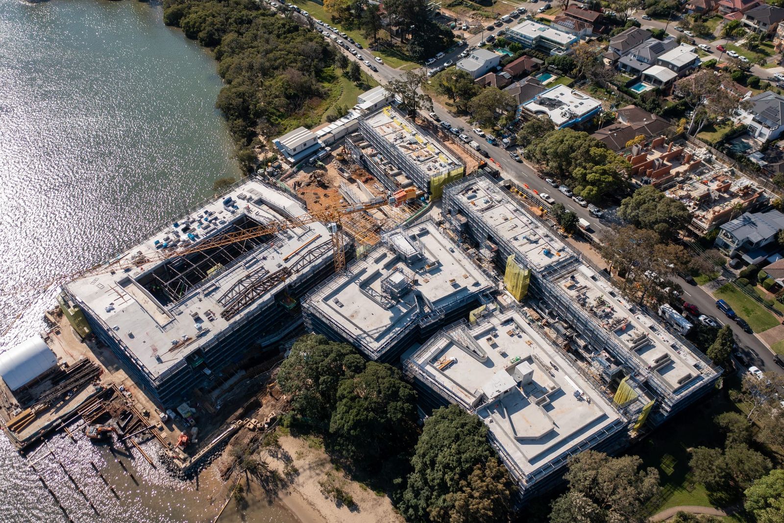 High view over the development and neighbouring streets, sunlight across the river