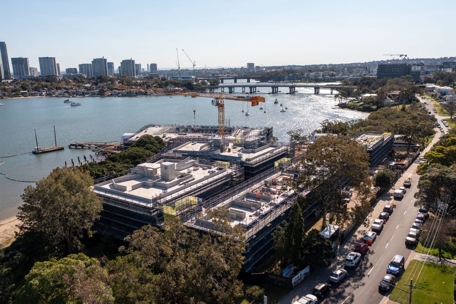 The development from the river side, a road bridge and the Rhodes towers across the water